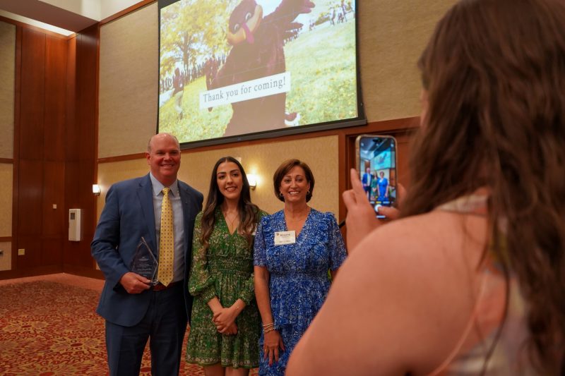 Tom Winters, scholarship recipient Marah Ghanem, and Shauna Winters stand for a photo at the Grado Department of Industrial and Systems Engineering's Academy of Distinguished Alumni induction ceremony.